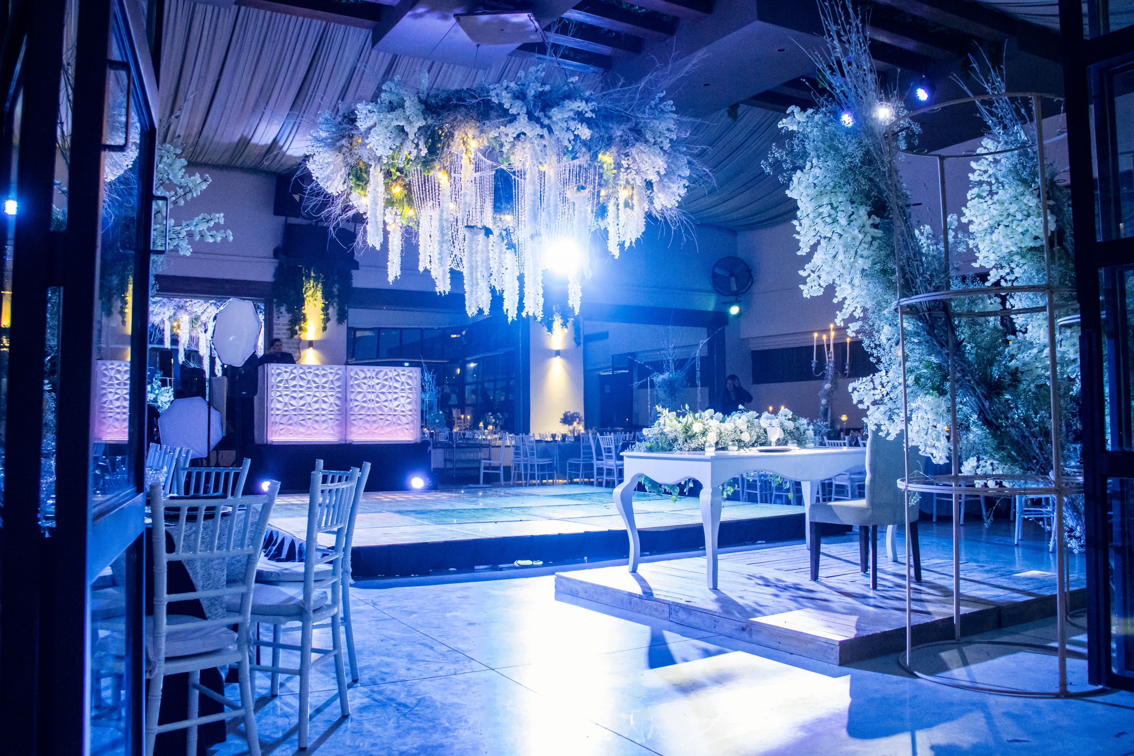 Reception hall with floral installation and DJ booth